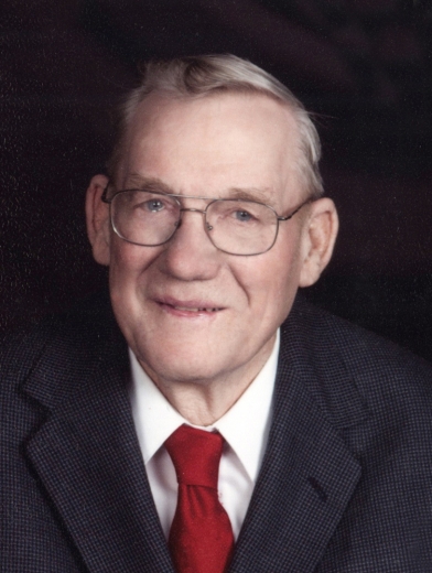 Alvin Walters gives a tentative smile. He wears a suit and tie.